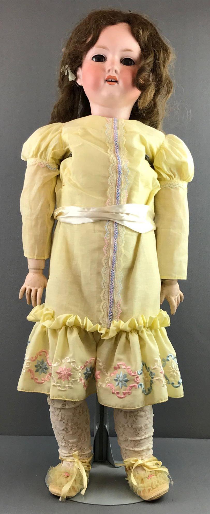 Antique 32 inch German bisque doll Marseille: Socket head, 390 A.13.M, stationary glass brown eyes with painted lashes, open mouth with teeth, wood and composition jointed body and hands. Human hair brown wig. Some paint loss on face, especially 