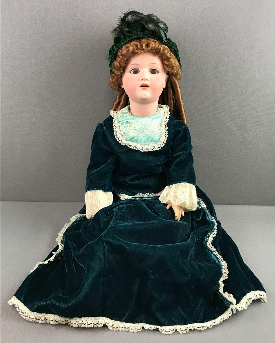 Antique 25 inch German bisque doll Heubach Koppelsdorf: Socket head, 250-6, brown sleep eyes with painted lashes, open mouth with teeth, composition and wood jointed body. Green velvet and lace dress and under garments. Chipping at some joints and neck. Ey