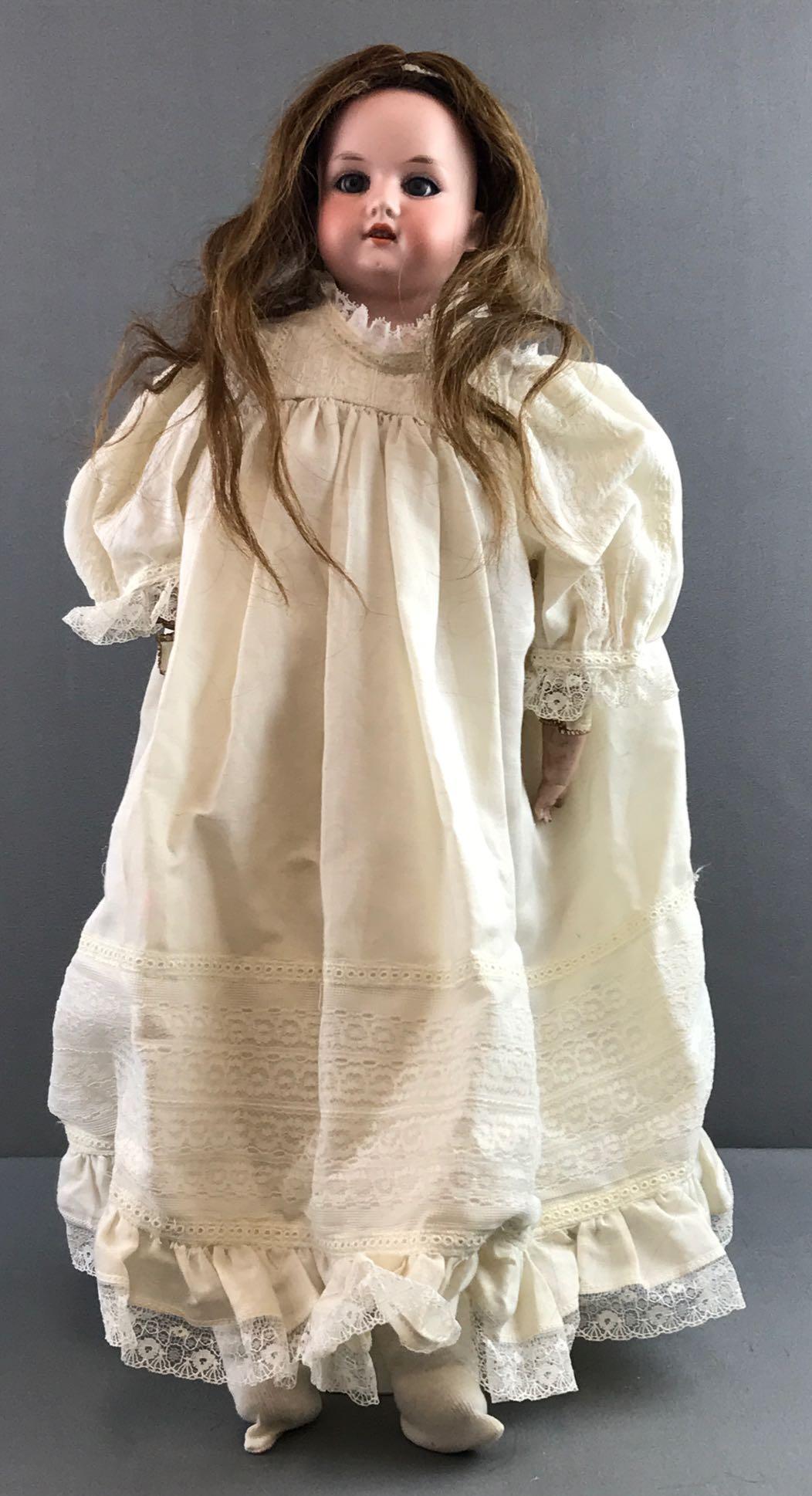 Antique 23 inch German bisque doll Marseille: 370, AM 0 1/2 DEP, Armand Marseille. Shoulder head, Blue stationary glass eyes with painted lashes, open mouth with teeth, leather body with bisque hands. White dress with lace, stockings. Brown hair 