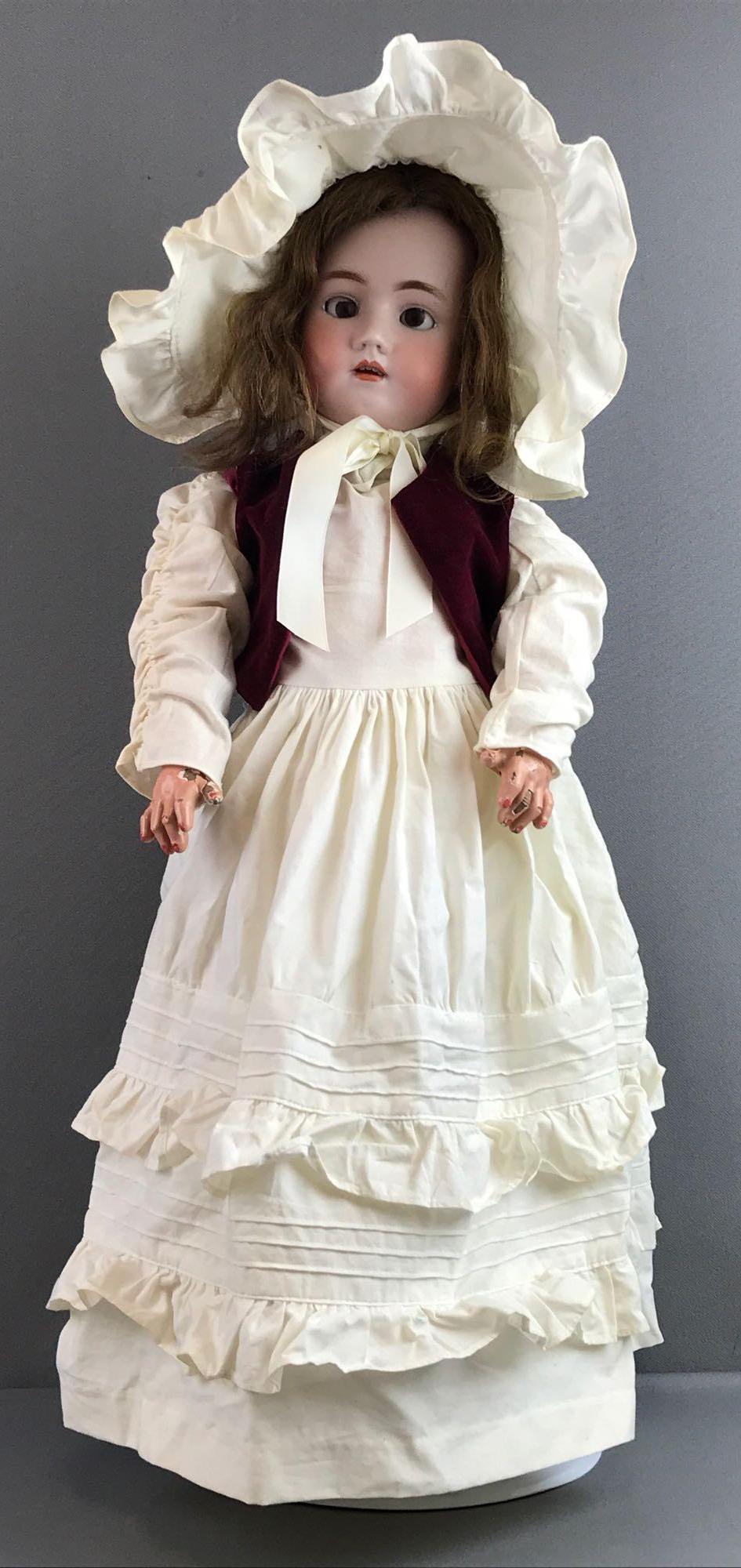 Antique 24 inch German bisque Simon & Halbig: Heinrich Handwerck Simon & Halbig, 4. Socket head, Brown stationary glass eyes with painted lashes, open mouth with teeth, composition and wood jointed body, pierced ears. White dress, velvet vest, bo