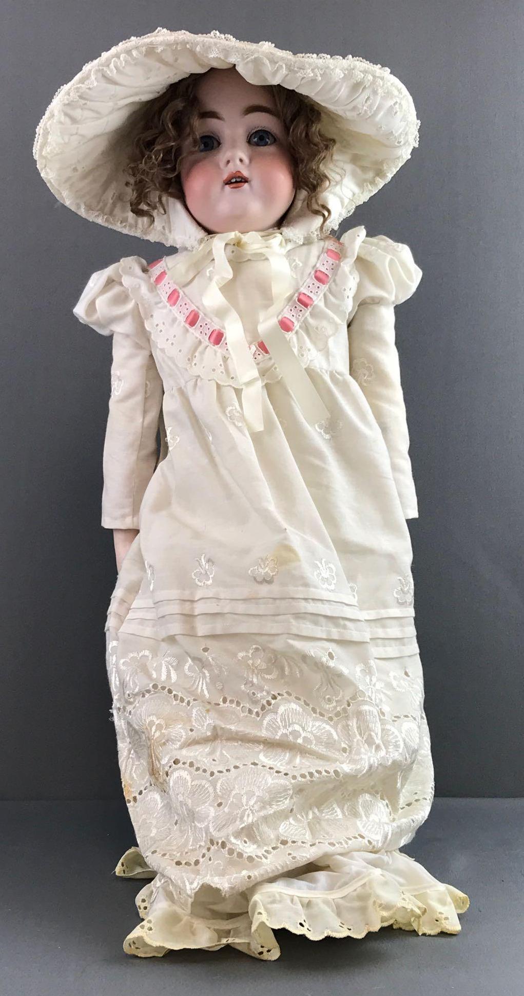 Antique 28 inch German bisque doll Kestner: Back of head reads Dep 154.15. Shoulder head, blue sleep eyes with painted lashes, open mouth with teeth, leather jointed body with bisque arms. White dress, under clothing, stockings, bonnet. Brown w
