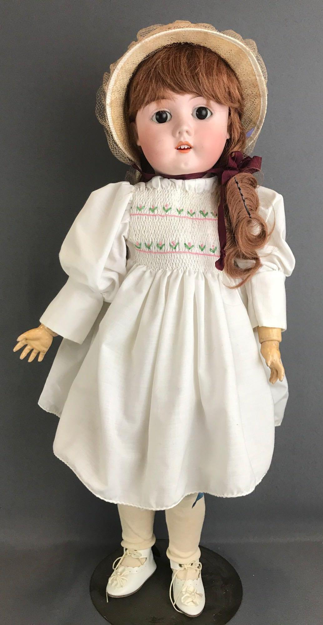 Antique 26 inch German bisque doll Handwerck: 283/32 Max Handwerck, Germany, 5 1/2. Socket head, Brown glass stationary eyes, composition and wood jointed body, open mouth with teeth. White smocked dress, hat, under garments, stockings, shoes. Us