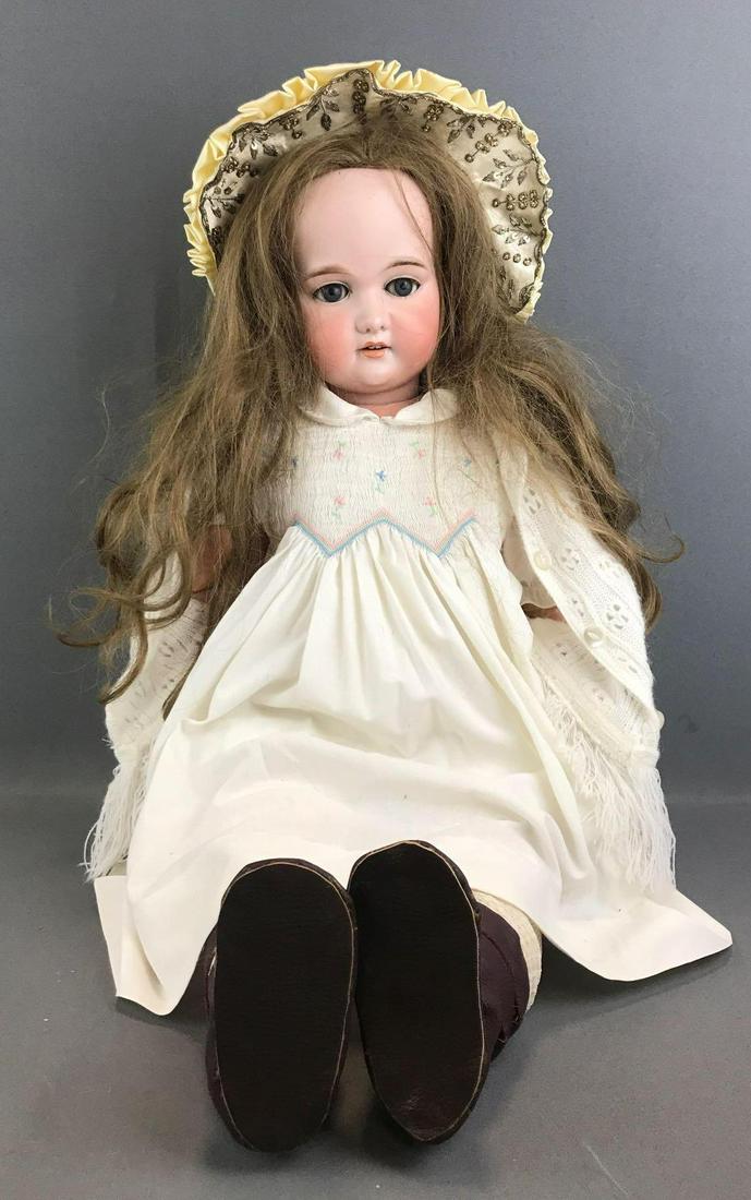 Antique 36 inch German bisque doll Marseille: A 15 M. Socket head, blue glass sleep eyes with painted lashes, open mouth with teeth, composition and wood jointed body. Brown replacement wig. White smocked dress, bloomers, bonnet, socks and boots.