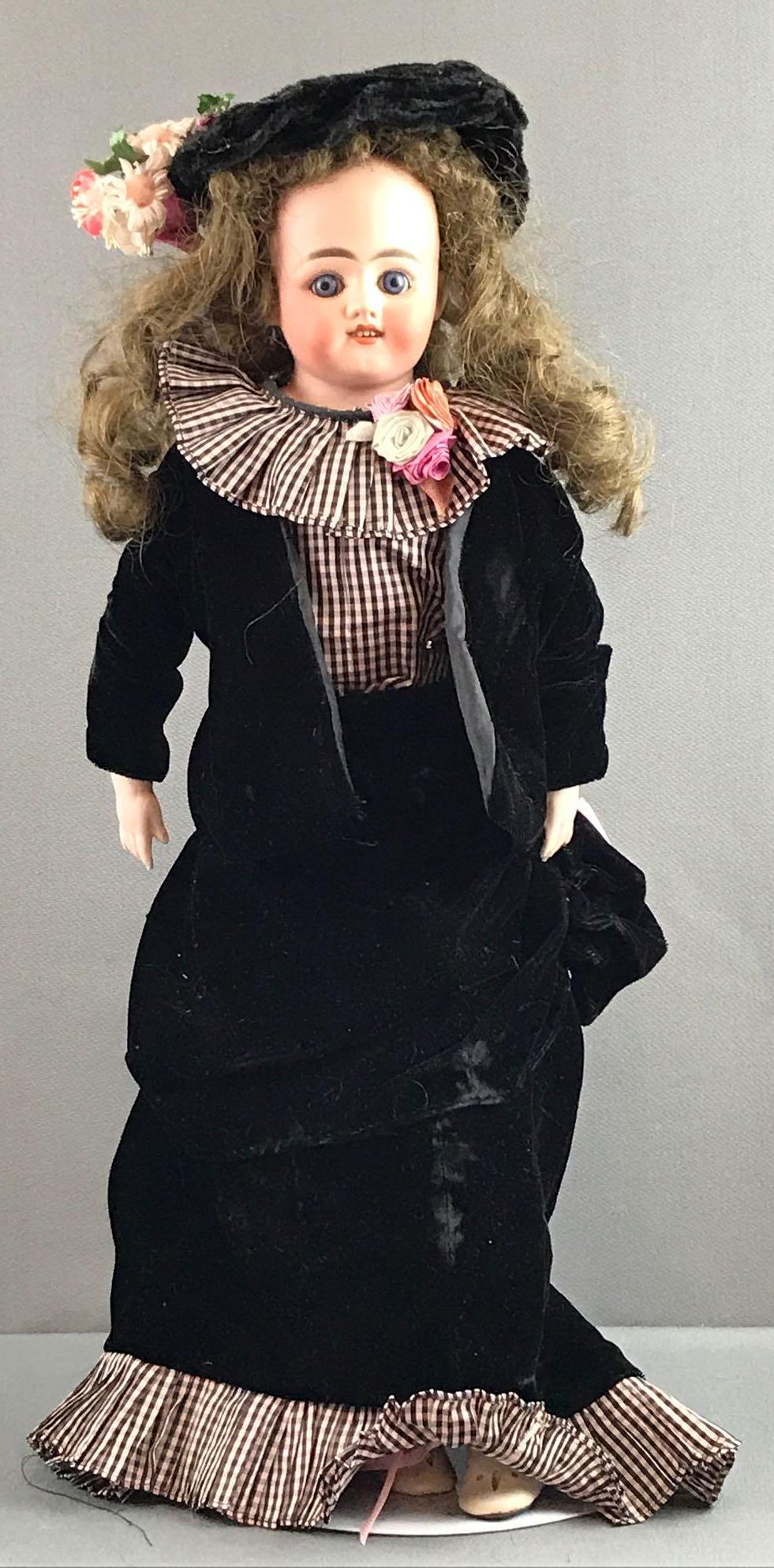 Antique 21 inch bisque doll: Head is only marked DEP, no other markings. Shoulder head, blue glass stationary eyes, open mouth with teeth, leather jointed body with bisque hands. Brown wig, partially attached. Black velvet outfit