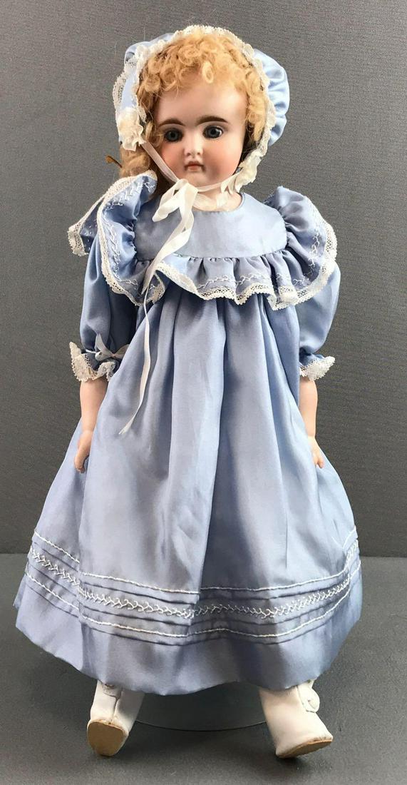 Vintage 14 inch German bisque closed mouth doll: Back of head is marked 61, 5. Shoulder head, blue glass stationary eyes with painted lashes, closed mouth, leather body with bisque arms. Blue dress and bonnet, under garments, socks, boots. Blonde mo