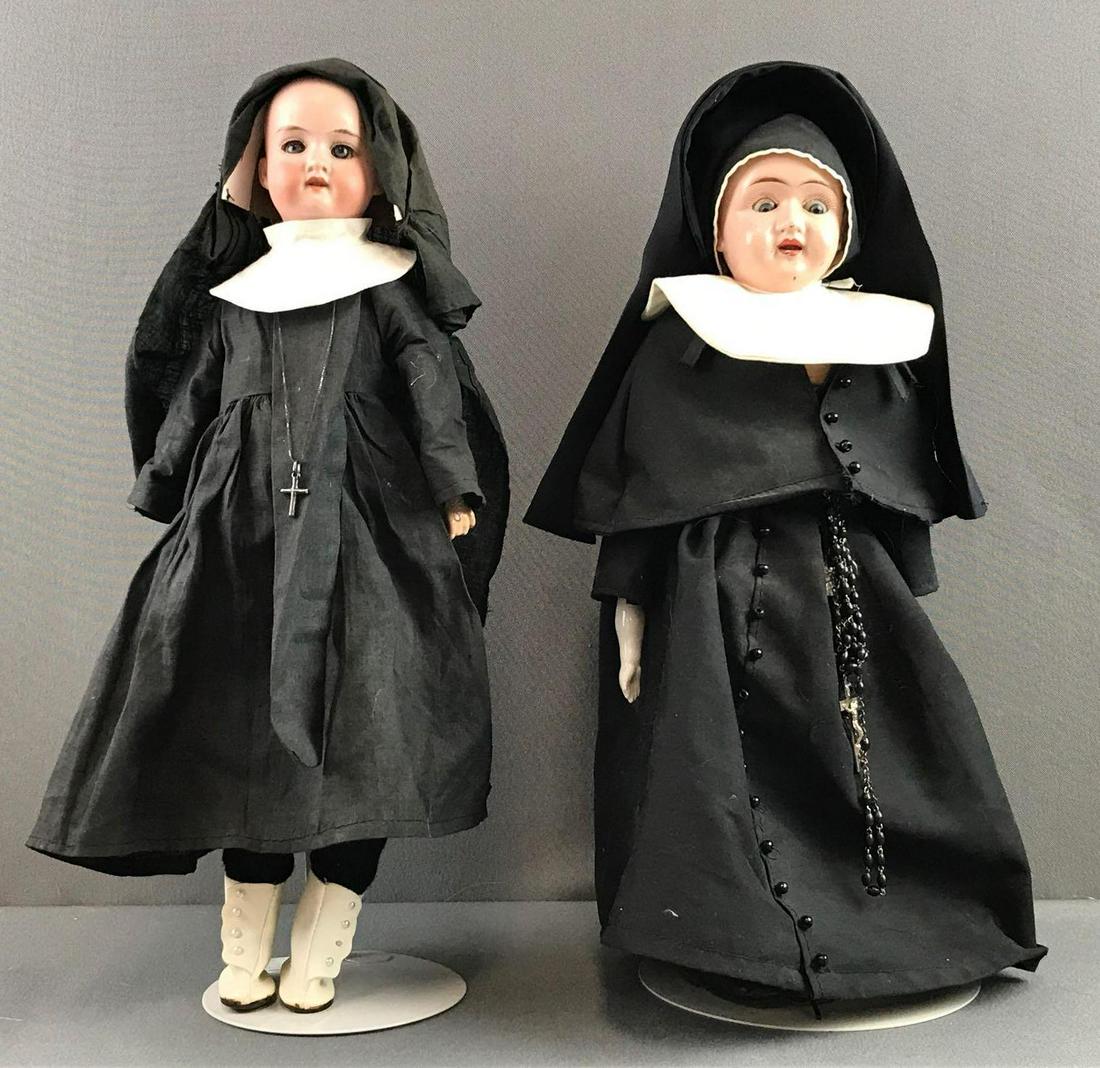 2 antique nun dolls: Largest measures 15 inches. Bisque Armand Marseille, unmarked composition head. Both have some wear from use and age. Doll stands not included.
