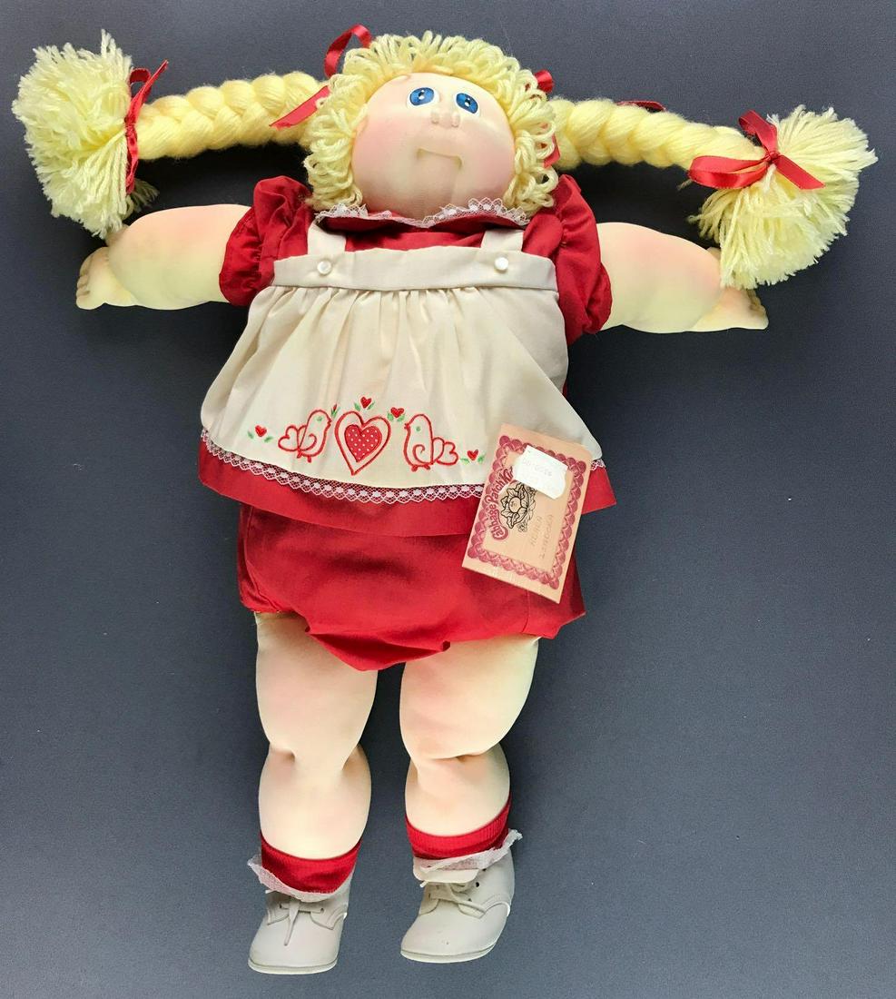 Soft sculpture Cabbage Patch Kid 1984: Manufactured 1984, with tags. Very good condition, no birth certificate. Hang tag has a JCPenney price tag.