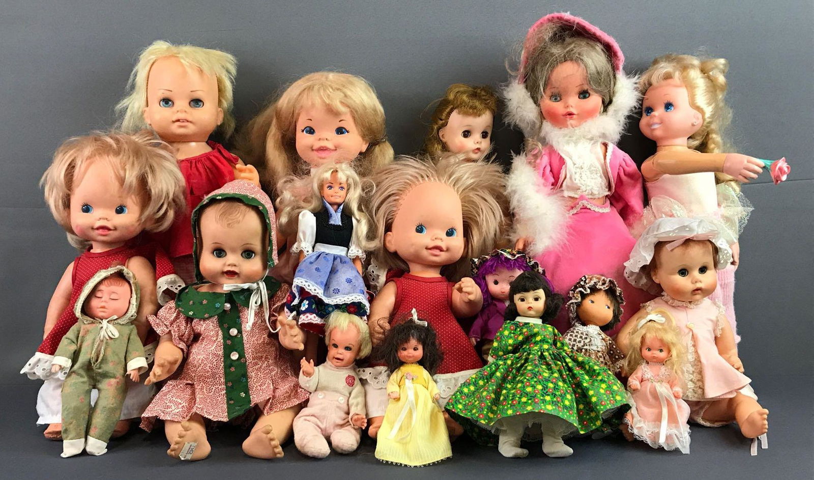 Group of 17 assorted dolls: Includes sleepy eye dolls by Mattel, Alexander, Chatty Cathy and more. Largest measures 17.25x9x5 inches. Some markings, disconnected joints, and clothing stains, in used condition.