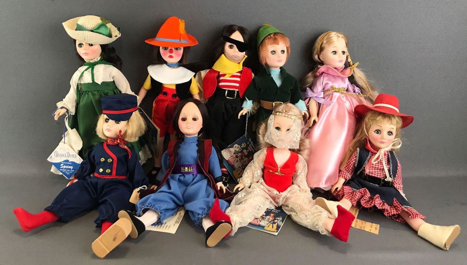 Group of 9 assorted Effanbee dolls: Includes Storybook Collection Rapunzel, International Collection Turkey, A Collection of Grandes Dames Four Seasons Spring, and more. Dolls are 11 inches each. Unknown completion