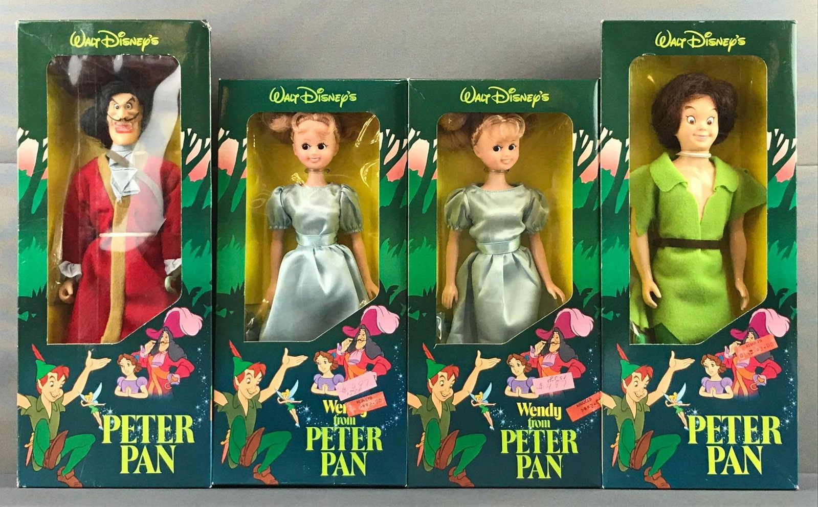 Group of 4 Walt Disney Peter Pan Dolls: Includes Peter Pan, Wendy and Captain Hook measuring 14x5.75x2 inches. Like new condition, includes duplicates.