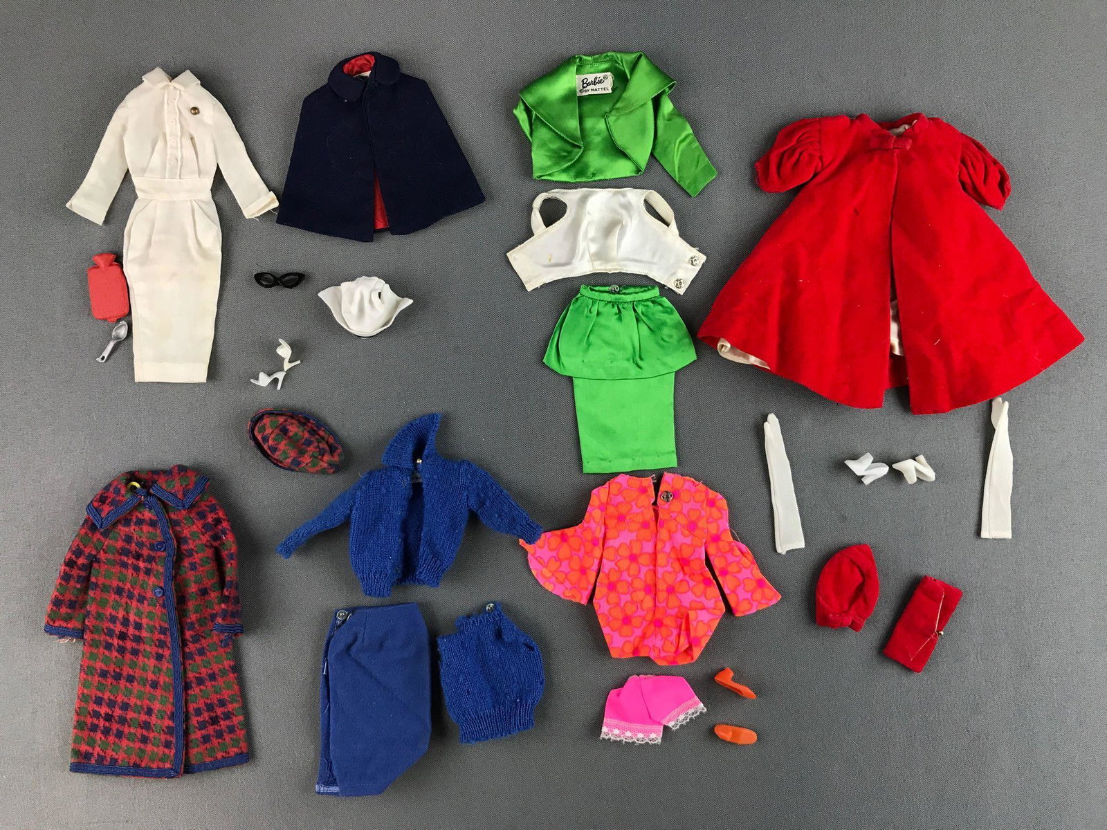 Group of 28 Mattel Barbie Fashion Clothing, Shoes and: Includes Nurse outfit and accessories, velvet coat and accessories, sweaters, coats and more. In used condition, some stains and rips.