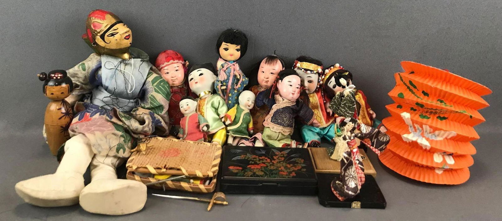 Group of Appx 20 pieces Asian/Asian inspired dolls and: Wooden nesting doll, marionette, porcelain, and more. Largest is 16 inches