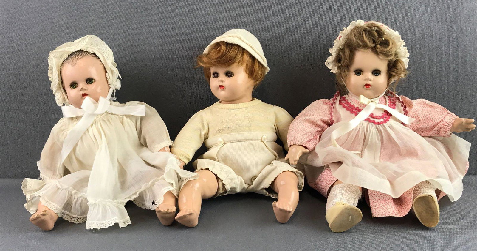 Group of 3 Madam Alexander dolls: Includes sleepy eyes babies with soft bodies and composite heads. Measures 12 inches. Some paint chipping and cracking, wear consistent with age and use.