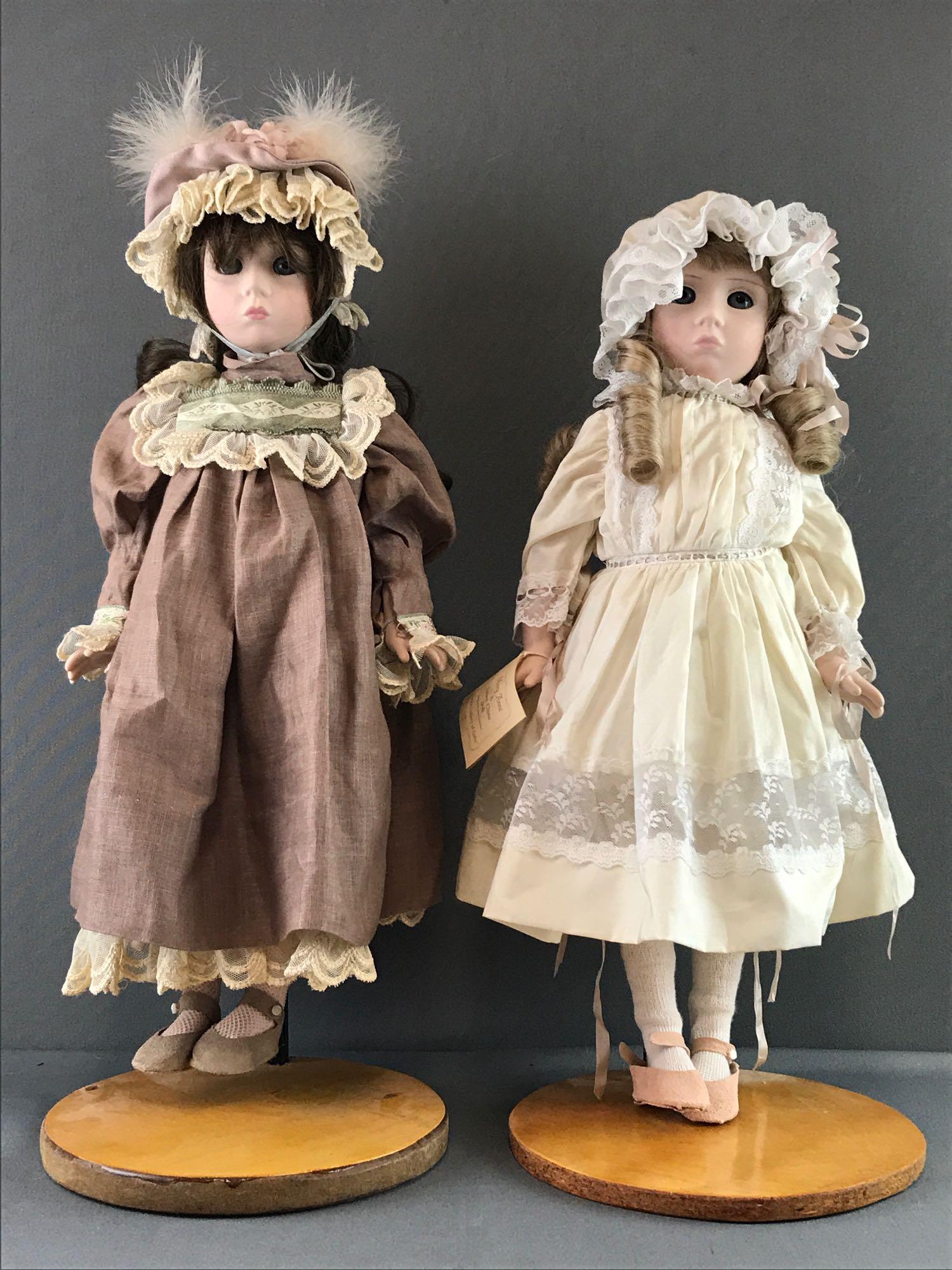 Group of 2 Lenox China dolls: Measures 19 inches. Button missing on pink ballerina shoe. Wear consistent with age.