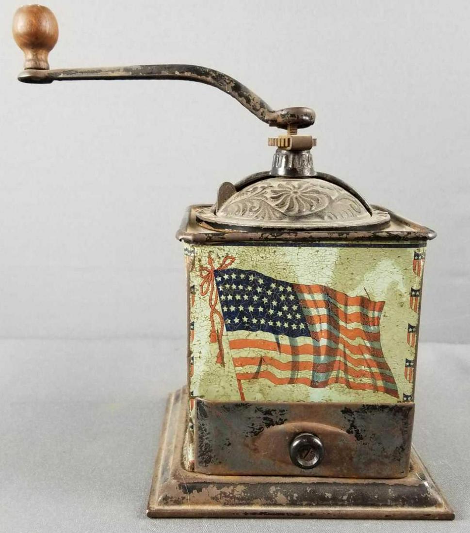 Vintage patriotic metal coffee grinder/mill: Base measures 6 x 6 inches. Hand crank. Shows wear consistent with age and use.