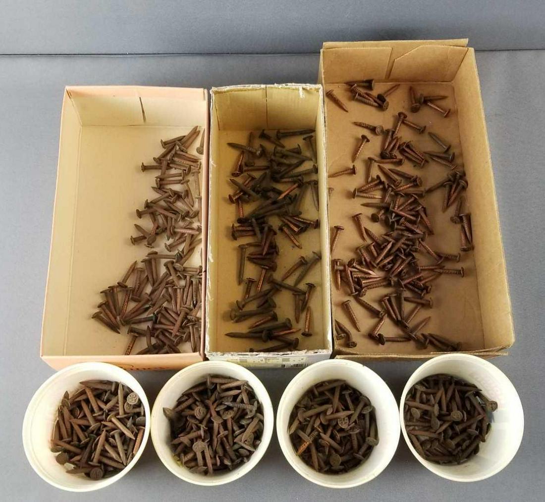 Large group of copper and other railroad date nails: These are separated, possibly by railroad line.