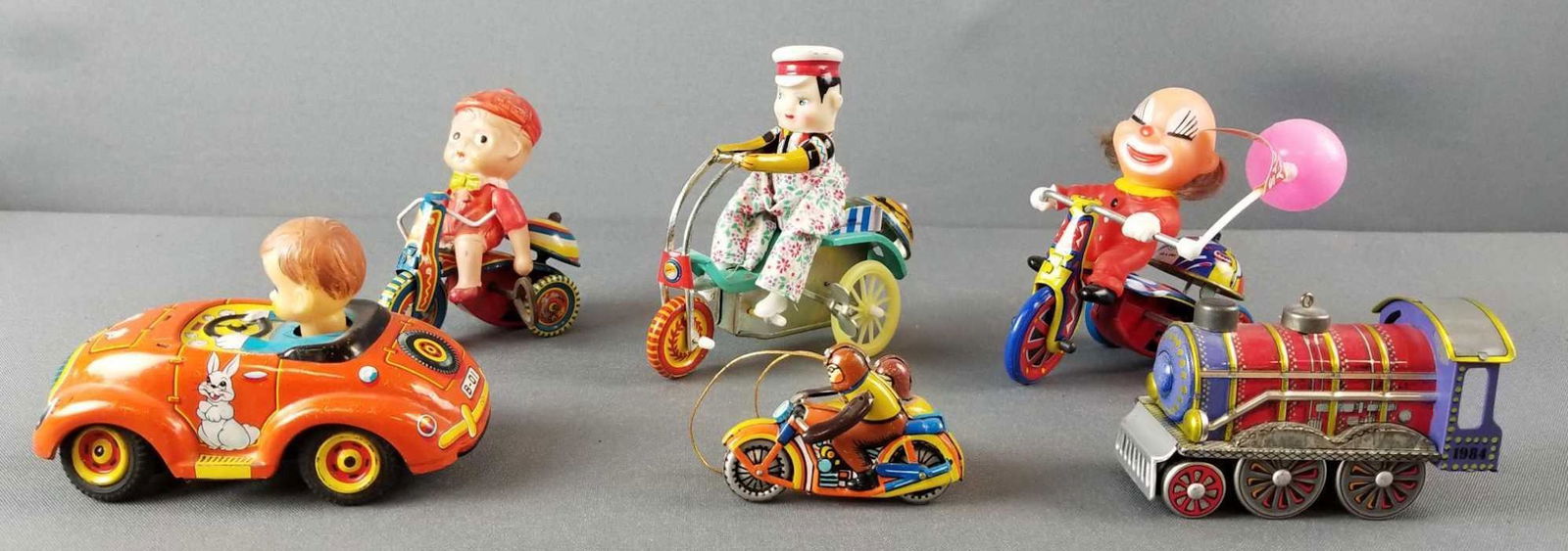 Group of 6 vintage vehicles: Some tin wind up toys. Largest is 4.5 inches tall