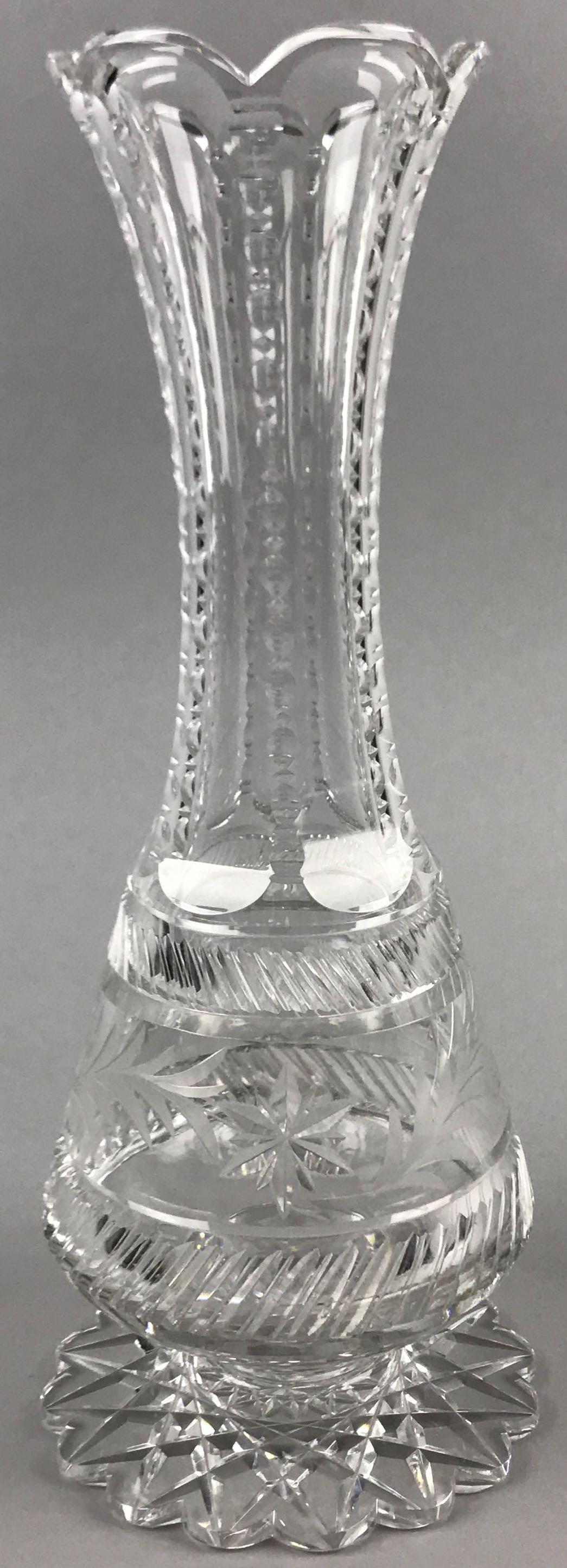 American Brilliant Period Cut Glass Footed Vase: 12 inches tall. Star leaf and cut prism pattern; some minor chips and wear consistent with age and use