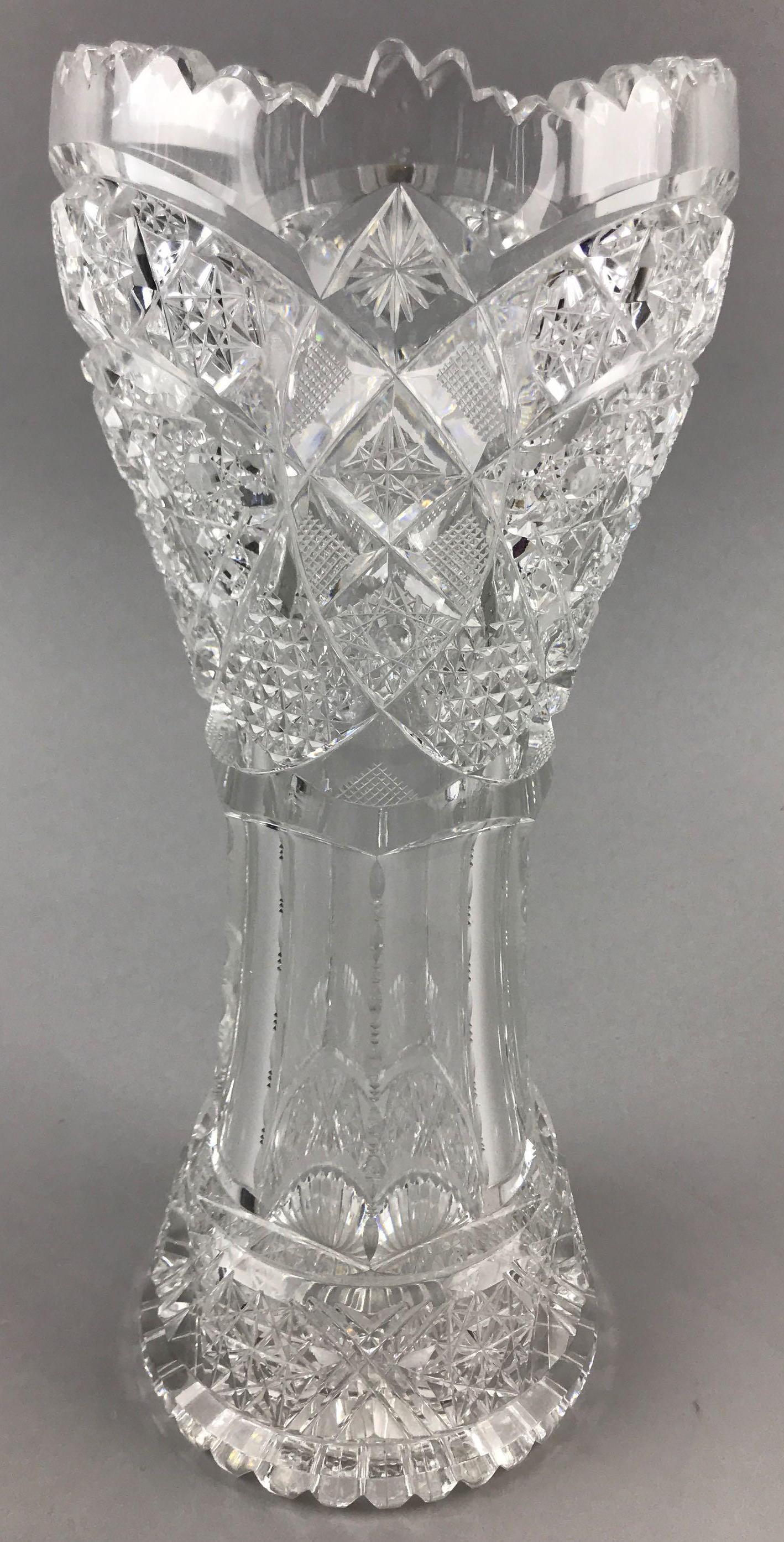 American Brilliant Period Cut Glass Corset Vase: 11 1/2 inches tall. Star and crosshatch pattern;minor flea bites and a couple slightly larger chips; base scuffing consistent with age and use