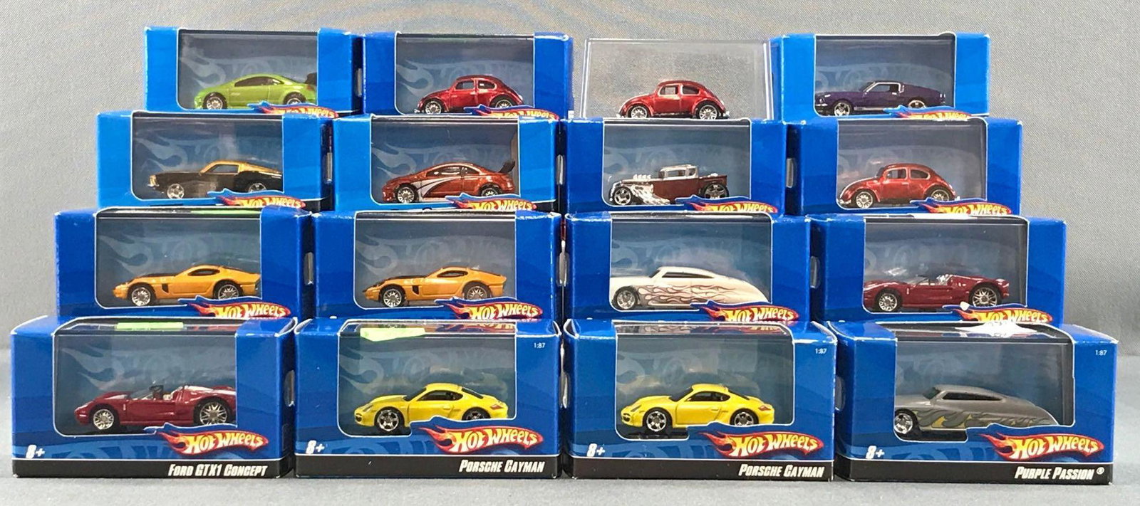 Group of 16 Hot Wheels in display cases: 1:87 scale, includes Purple Passion, Ford GTX1 Concept, Bone Shaker and more die-cast, all but one MIB.