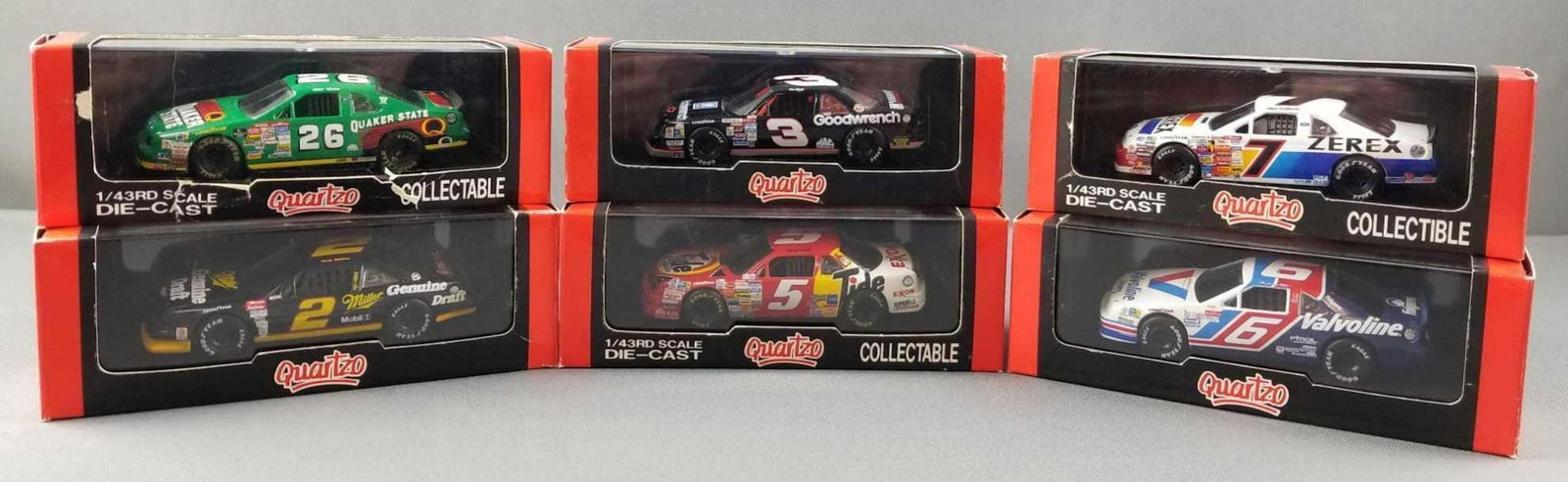 Group of 6 die cast replica racing cars: 1:43 scale, Quartzo, in original packaging. Quaker State, Miller, Goodwrench, Tide, Zerex, Valvoline