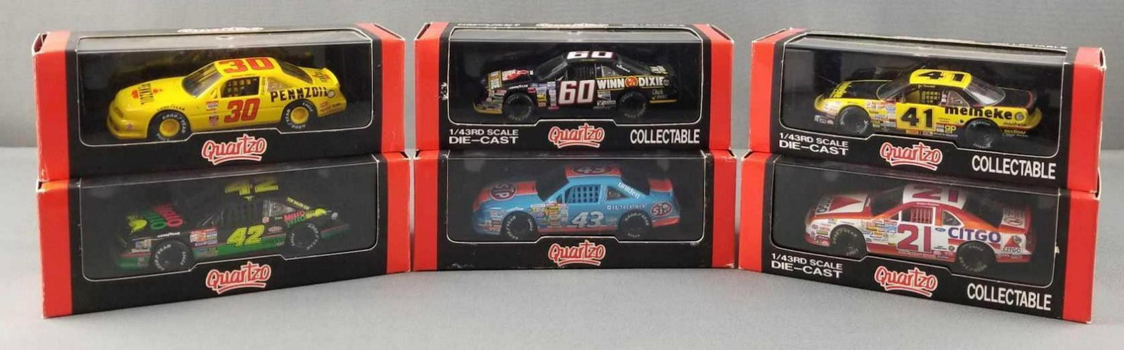 Group of 6 die cast replica racing cars: Quartzo, 1:43 scale, in original packaging. Pennzoil, Mello Yello, Winn Dixie, STP, meineke, Citgo.