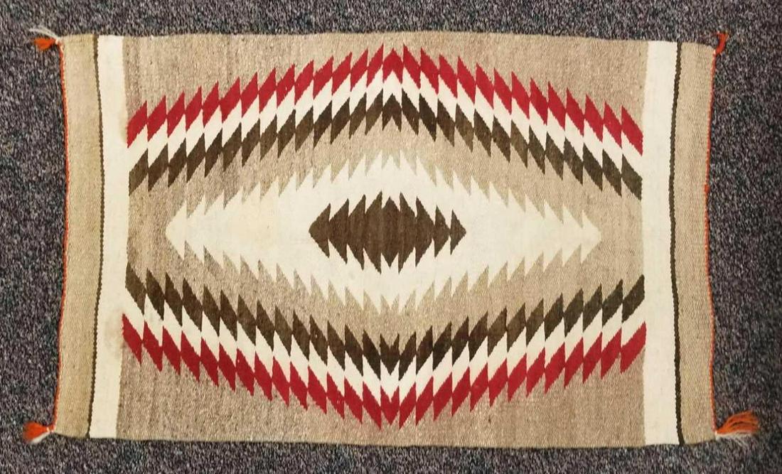 Native American rug: Browns and red, 42 x 27 inches. Some light stains