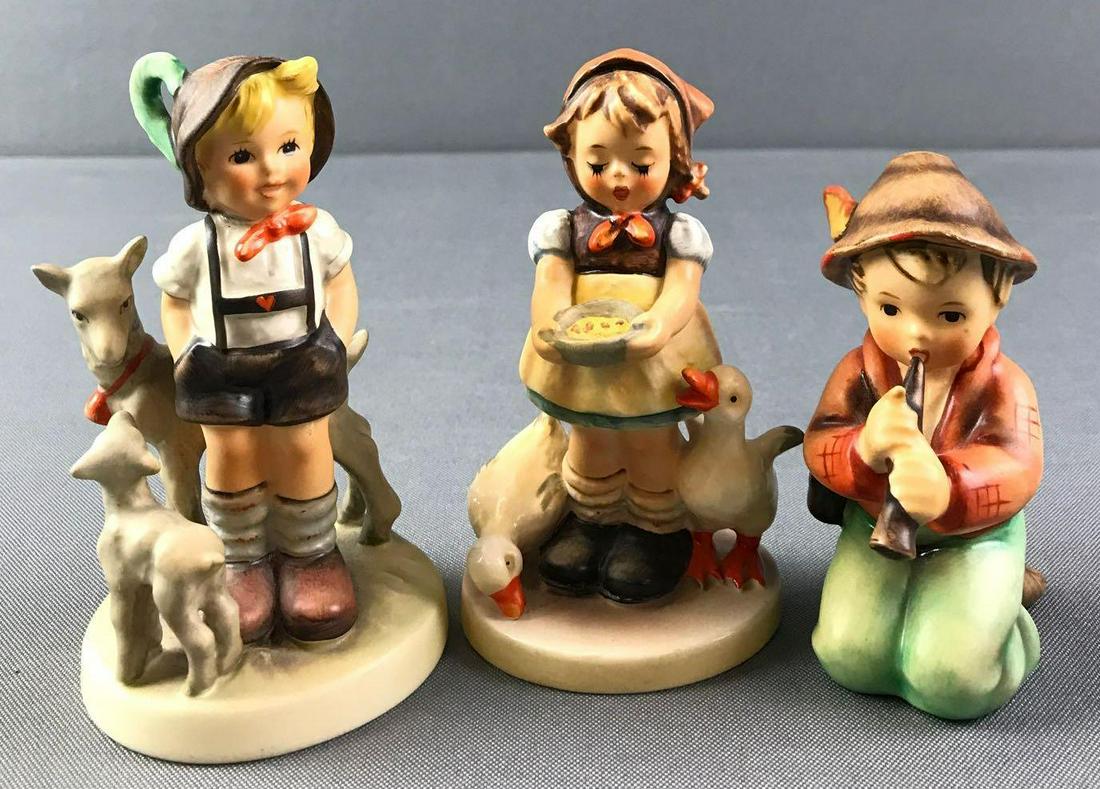 Group of 3 Hummel Figurines: Little Goat Herder, 200. Be Patient, 197. Little Tooter, 214. Tallest is 4.75 inches.