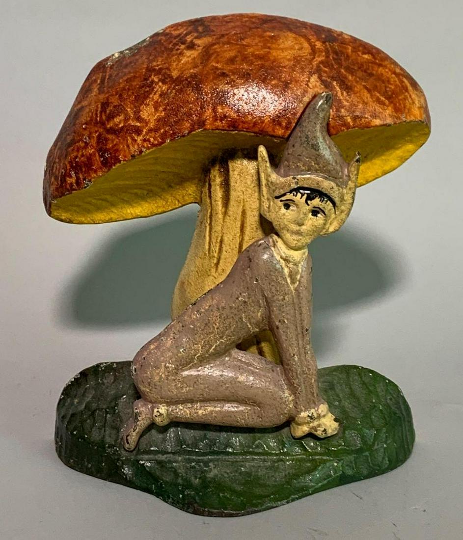Cast iron Elf and mushroom door stop: 3 x 6 x 7 1/2 inches