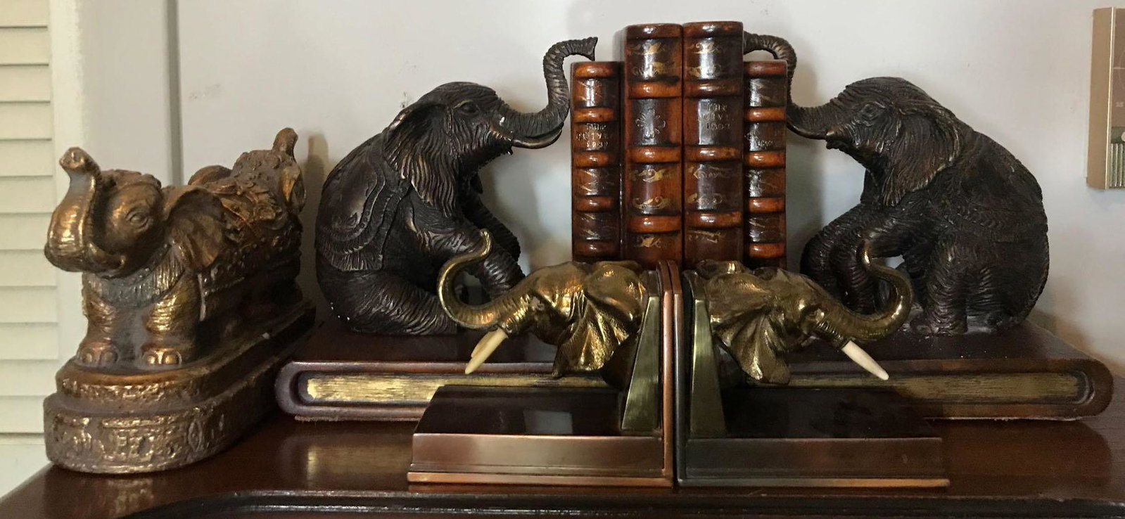 Group of 3 pairs of Elephant bookends: Assorted materials, loose tusk on smallest pair. Largest measures 9x7x8.5 inches each