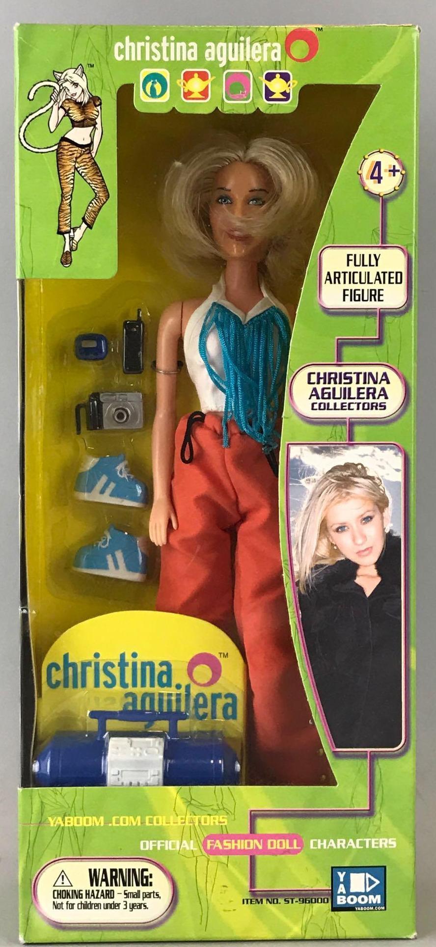 Yaboom Christina Aguilera fashion doll: 11.5 inch Fashion Collectors doll wears Orange warm ups with a white and turquoise fringed tank and turquoise trainers. New in original packaging