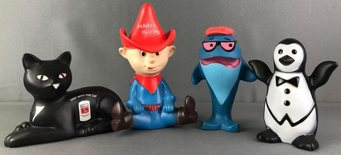 Group of 4 Licensed Rubber Banks and Toys: Includes Charlie Whale toy, Munsingwear Penguin toy, Marky Maypo Bank, and Save With The Cat Bank. Tallest is approximately 9 inches tall.