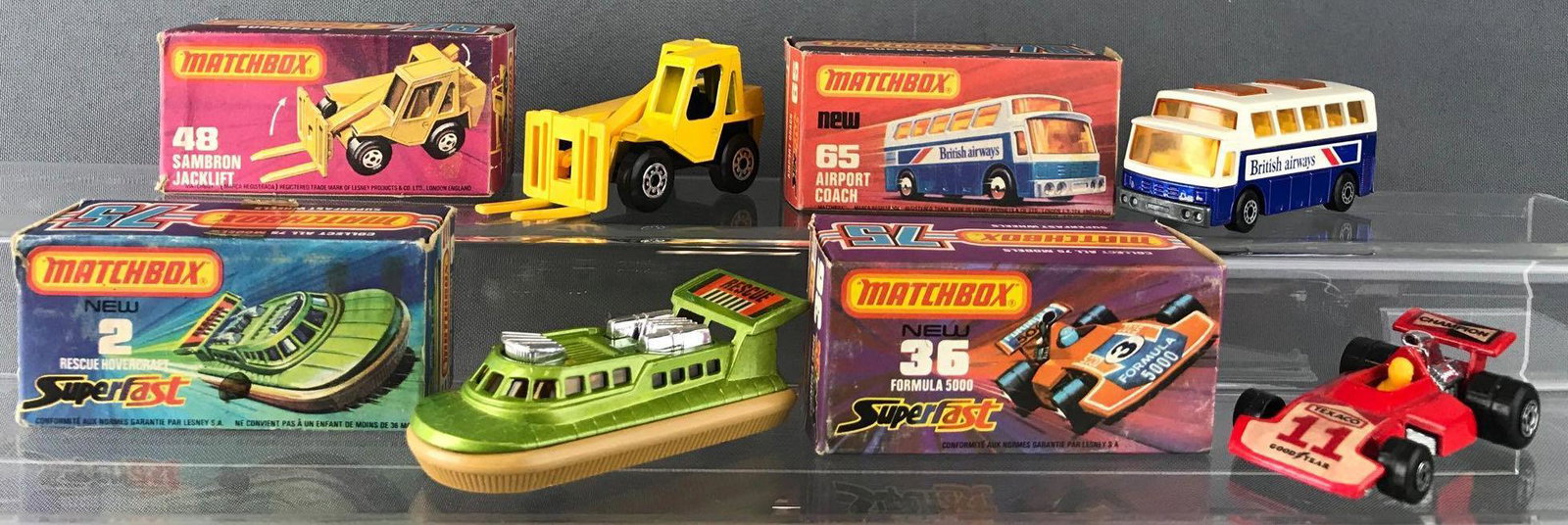 Group of 4 Matchbox Superfast die-cast vehicles: Includes No. 2 Rescue Hovercraft, No. 36 Formula 5000, No. 48 Sambron Jacklift, and No. 65 Airport Coach. A Lesney Product