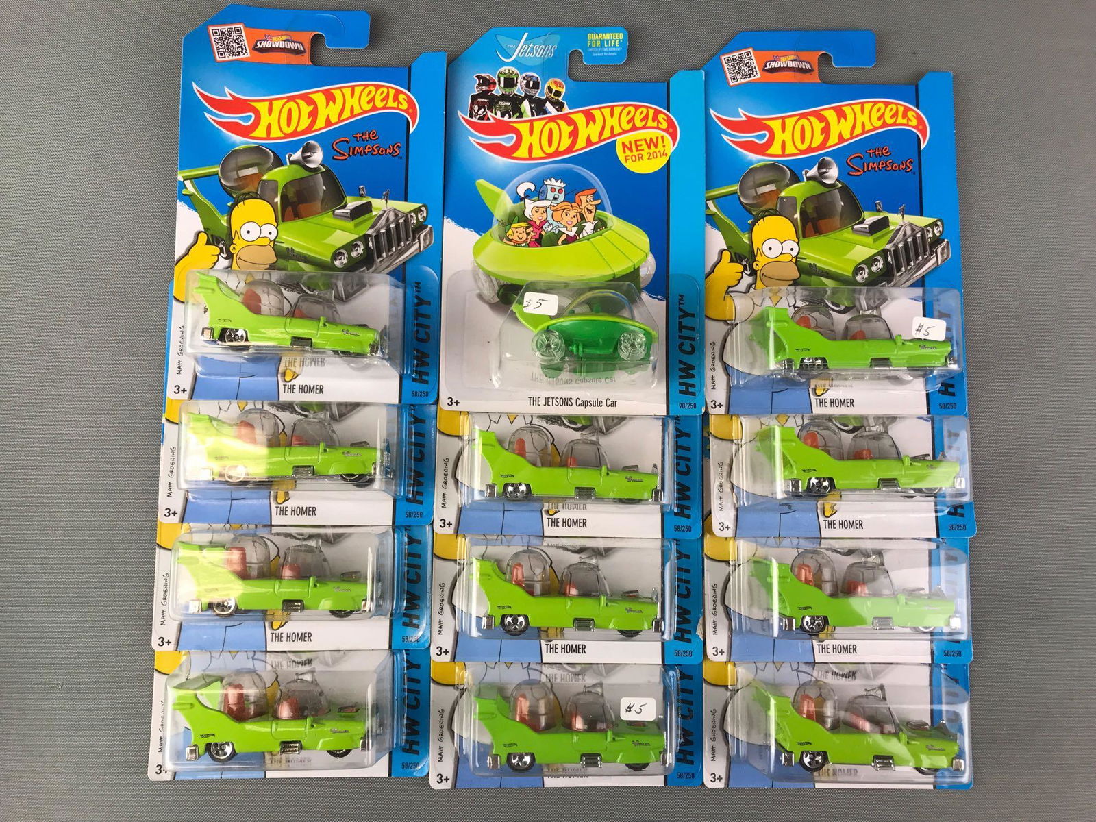 Group of 13 Hot Wheels Licensed Vehicles: Includes The Homer and The Jetsons Capsule Car, die cast, new in original packaging.