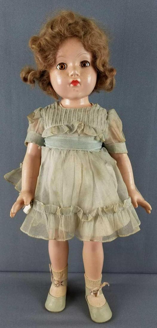 Effanbee composition doll: Brown sleep eyes with applied lashes. Some cracking to finish. Crack below eye. 21 inches tall. Back reads effanbee anne shirley
