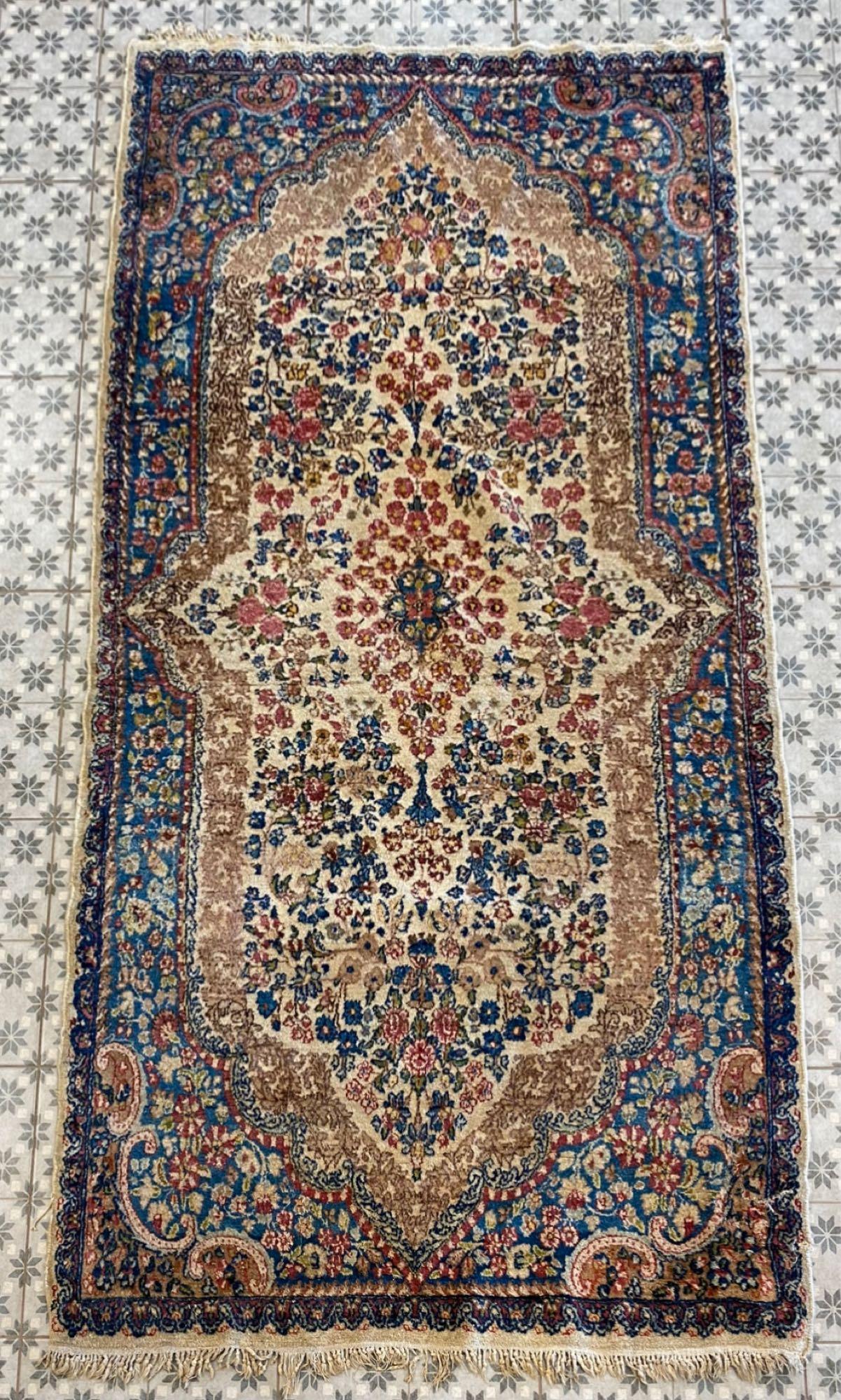 Floral Area Rug: Repaired corner, beige with blues, pinks and yellows, approximately 90X47.50 inches