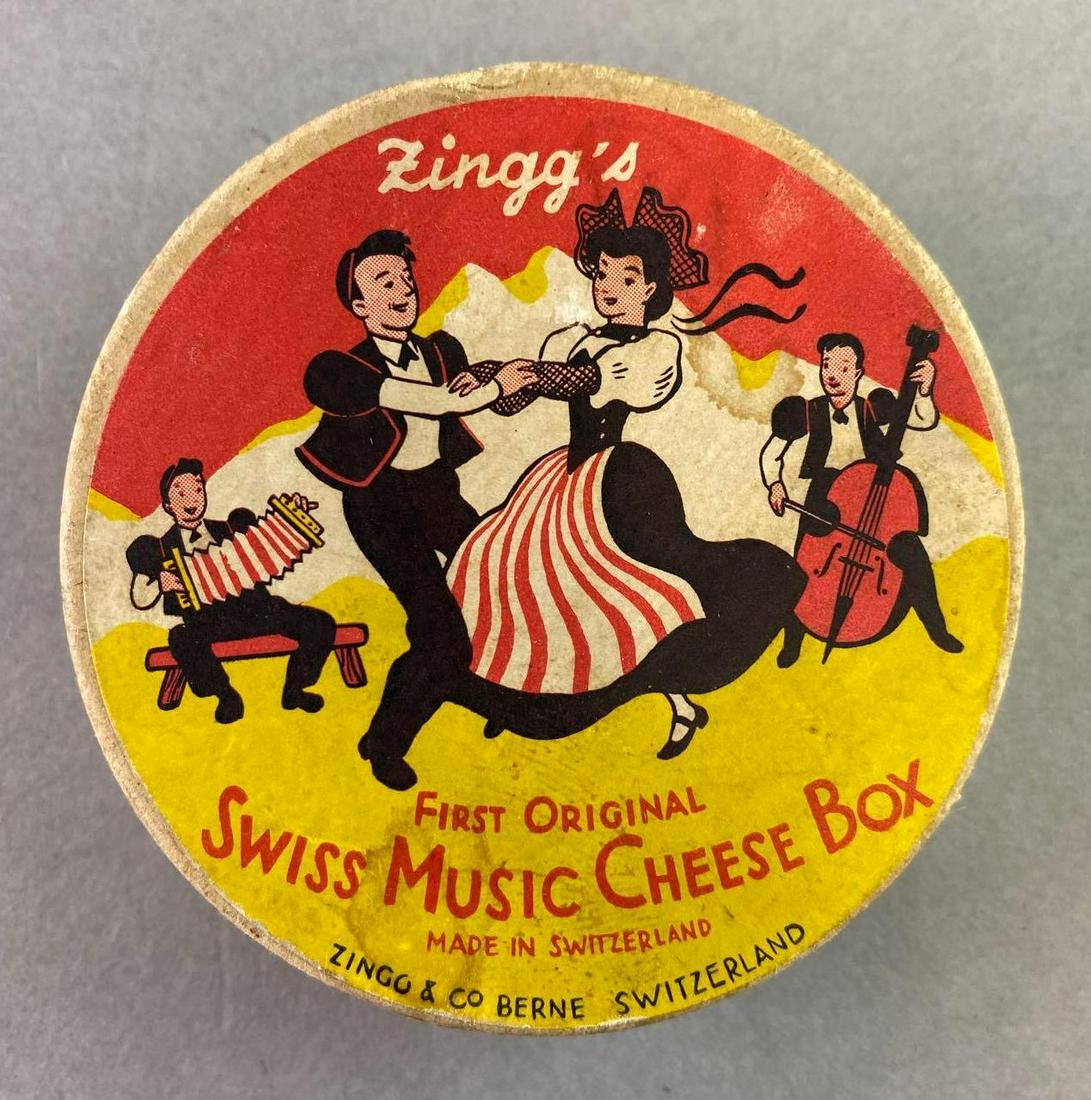 Swiss Cheese Music Box: Measures approximately 2 3/4 inches in diameter. Starts to play when lifted off the table