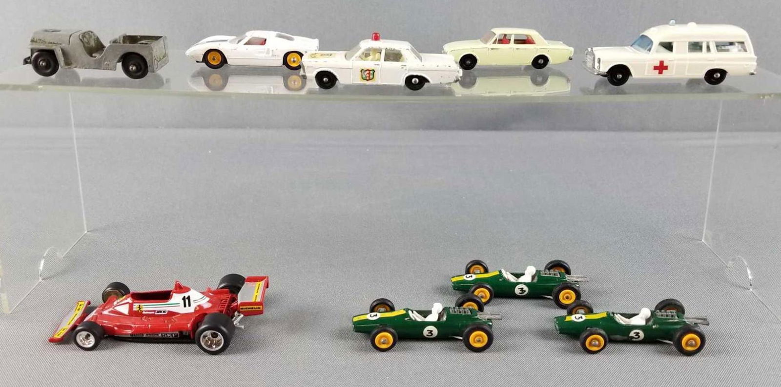 Group of 9 die cast toy vehicles: Lesney, Polistil. Some have loose tires. Includes lotus green with yellow wheels #3. Mercedes Benz ambulance white with black wheels, Ferrari 312T2 red formula 1 Polistil