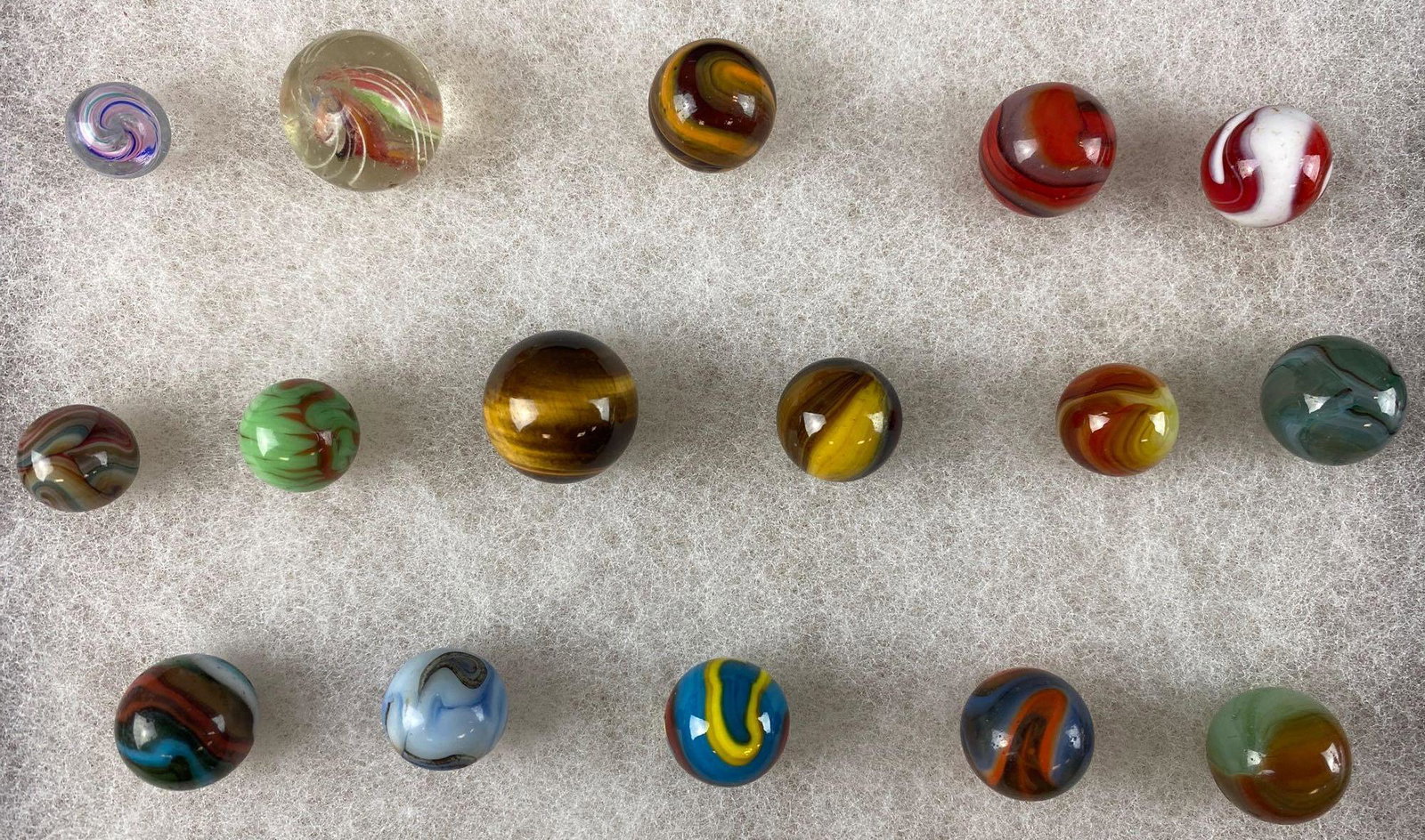 Group of 16 assorted marbles: Assorted sizes, types, and makers. Includes cats eye, swirl, peewee, Pelletier, and more