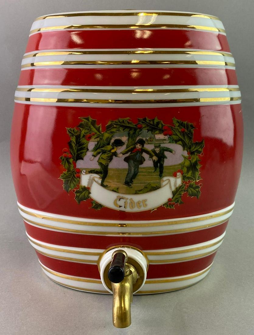 Twos Company Ceramic Cider Dispenser: Made by Twos Company and features a winter scene of boys ice skating. Measures approximately 10 1/2 inches tall by 9 inches wide. There are a couple of scratches in the red glaze. It holds 2 gallons.