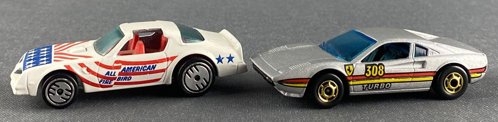 Group of 2 Hot Wheels die-cast vehicles: Includes Hot Bird-white, 1977, Malaysia and Racebait 308-silver, 1977, Hong Kong. Mattel, Inc.