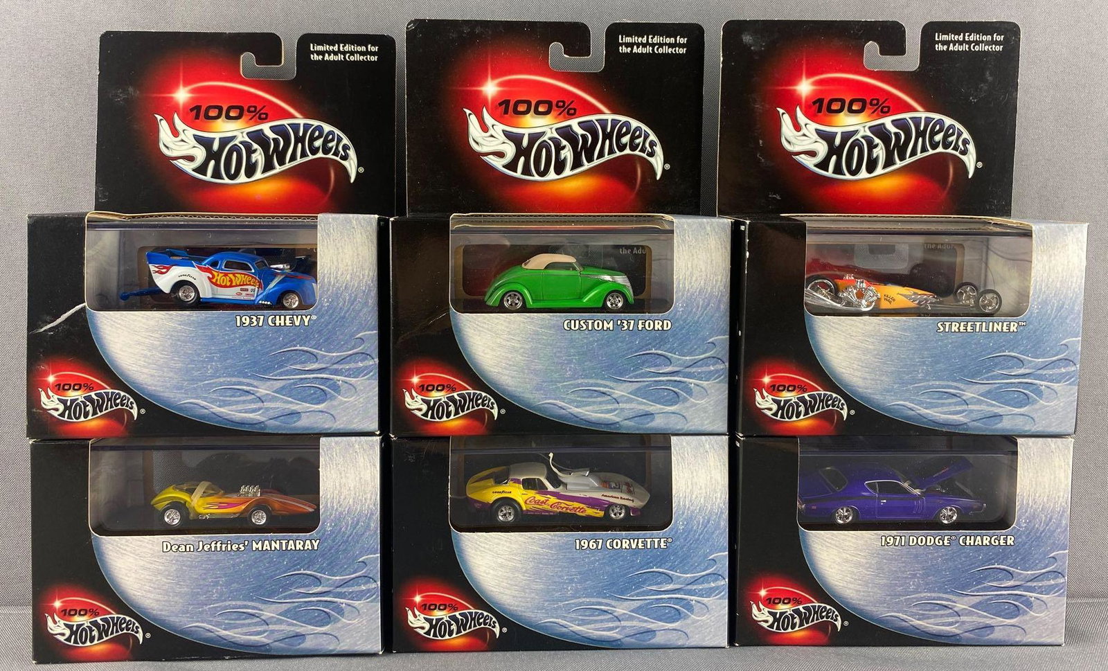 Group of 6 100% Hot Wheels die-cast vehicles: Includes 1937 Chevy. 1971 Dodge Charger, Dean Jeffries Manta Ray, and more. New in original factory sealed packaging. Mattel, Inc.