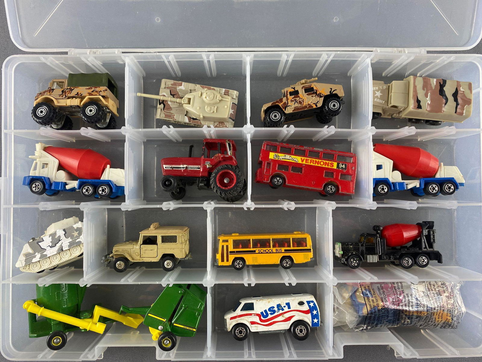 Group of 16 assorted die-cast vehicles in storage case: Includes Hot Wheels, Matchbox, Tomica, and more. Case measures 14x2x8.75 inches