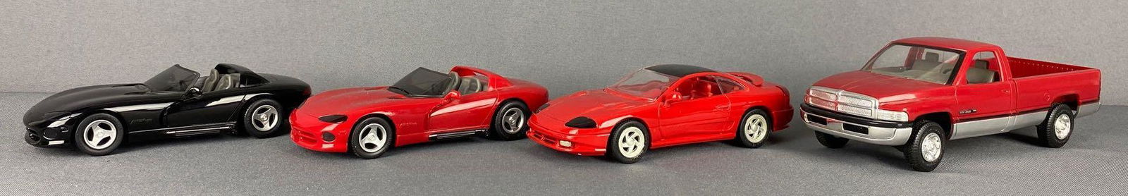 Group of 4 assorted Dodge Dealer Promo Cars: Includes 1994 Dodge Ram 2500 V10-red/silver, 1991 Dodge Stealth-Red, 1992 Dodge Viper RT/10 Convertible-red, and 1993 Dodge Viper RT/10 Convertible-black. Largest is 9x3.25x2.75 inches, all non-fricti