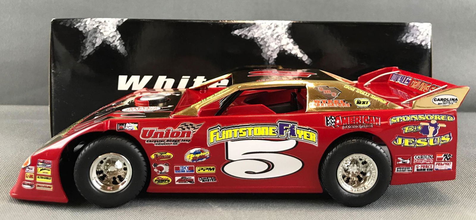 ADC White Series Mike Duvall ?Flintstone Flyer? No. 5: 1:24 scale dirt late model. Scratches/crazing throughout gold paint