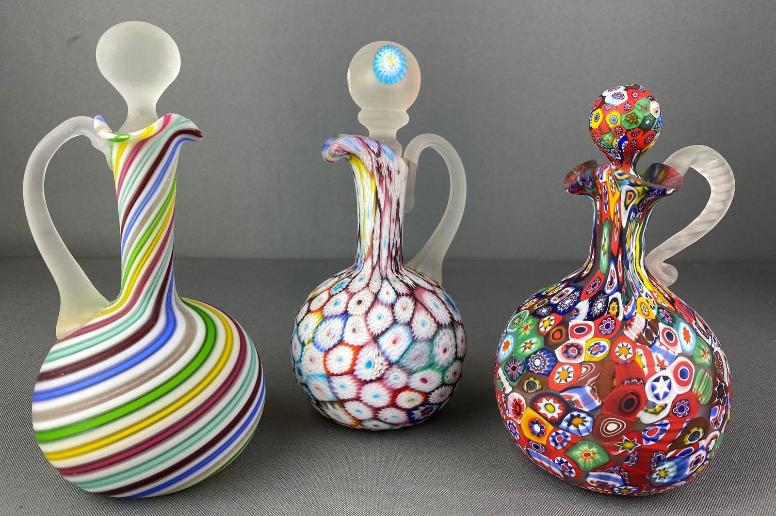 Group of 3 Millefiori Glass Cruets: Includes stoppers, stoppers have chips, all have pontil marks, tallest is approximately 7 inches tall