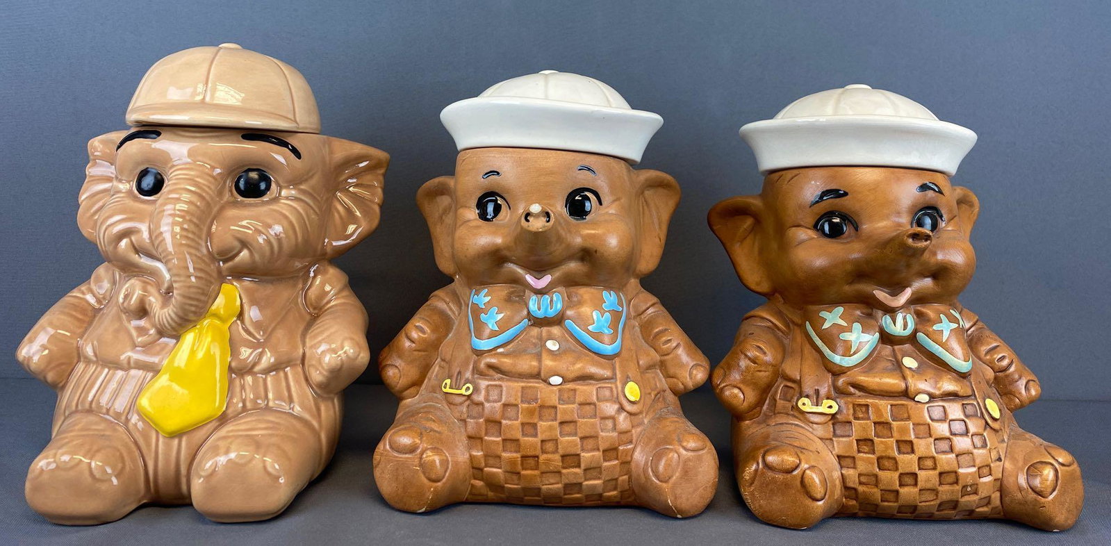 Group of 3 Elephant Cookie Jars: Cumberland Ware-appx 9.5x11.25 inches, some crazing, Twin Winton-appx 9x11.25 inches, similar cookie jar in center is unmarked, chip in nose