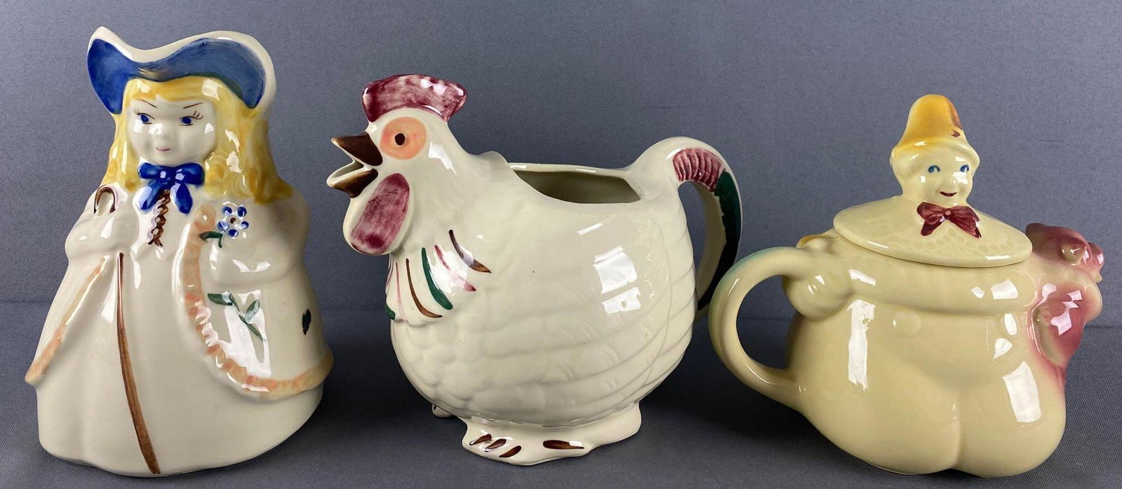 Group of 3 Shawnee Pottery pitchers: Little Bo Peep, Chanticleer, and Tom The Pipers Son. Largest is appx 10x6x7.5 inches