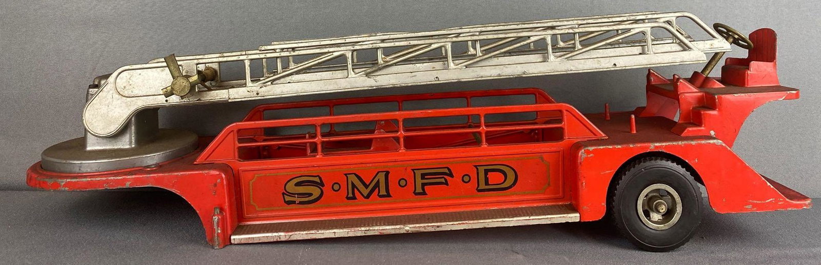 Smith Miller Smitty Toys Pressed Steel Aerial Ladder: Trailer only, no cab. 25.5x6x8 inches as pictured. Most original paint and decals remain, ladder raises and lowers, some minor damage