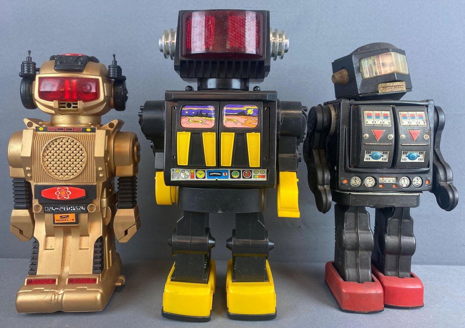 Group of 3 battery powered toy robots: Includes Kamco Cosmos Robot, Magic Mike, and Horikawa Space Explorer (tin). Unknown working condition. Largest is 12.25 inches
